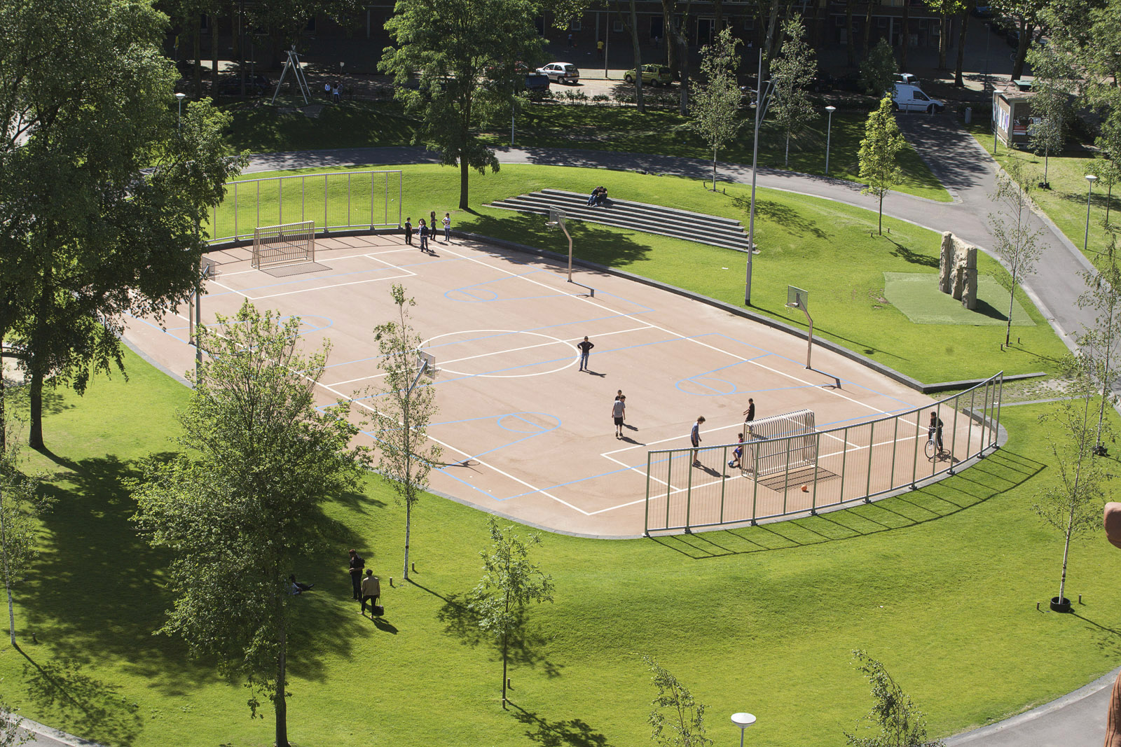 Sporting field, climbing object, stand, playing facilities and a multi functional path